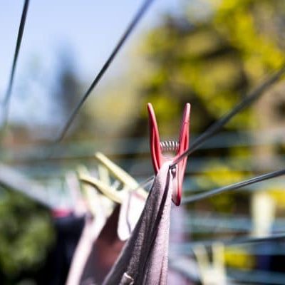 Laundry out to dry pegged to a rotary airer on a warm sunny spring day with sallow depth of field Outdoor washing drying in the sun